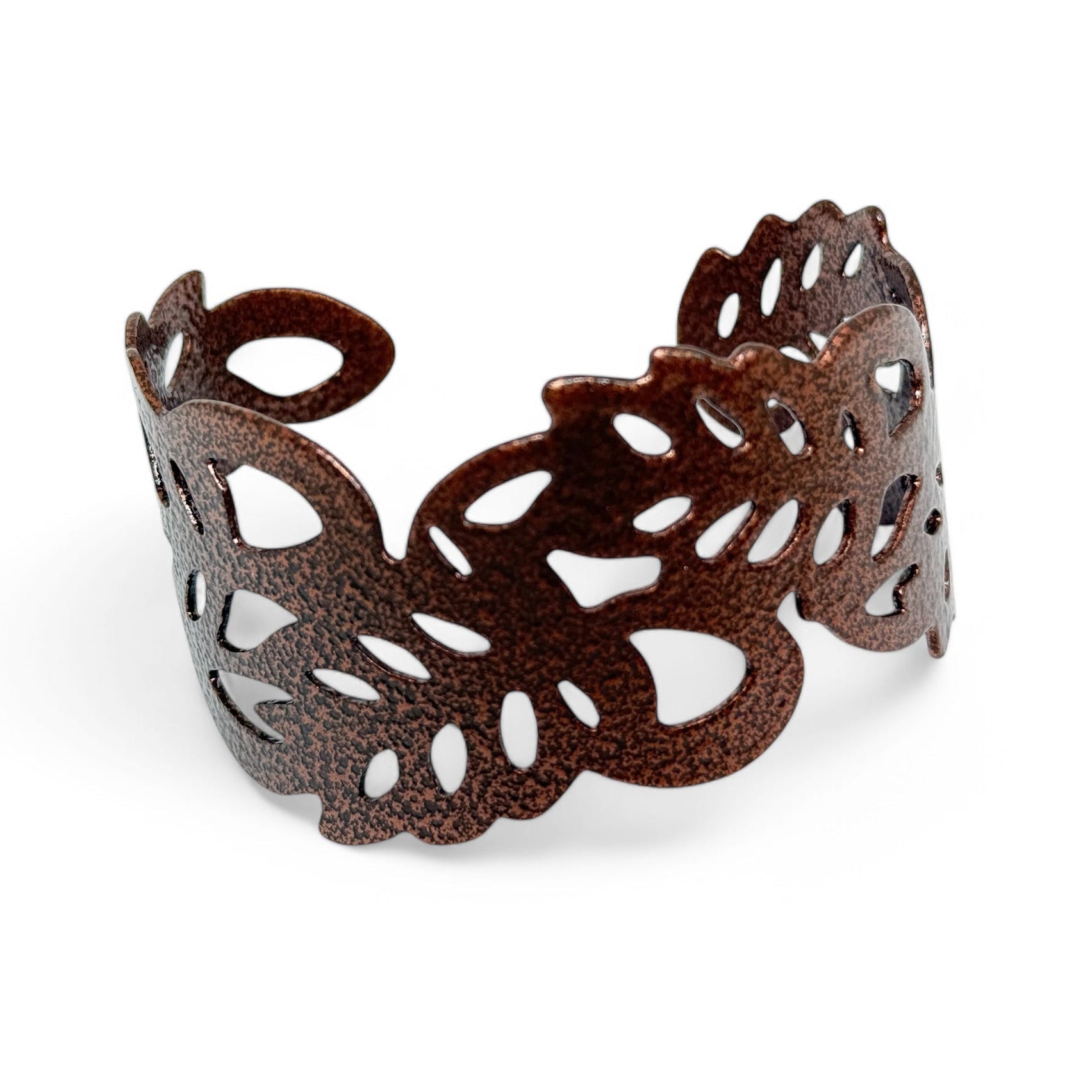 Copper enamel cuff bracelet with intricate cut-out design on a white background