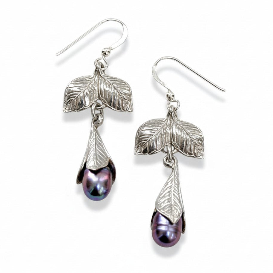 Silver leaf earrings with purple pearls on a white background