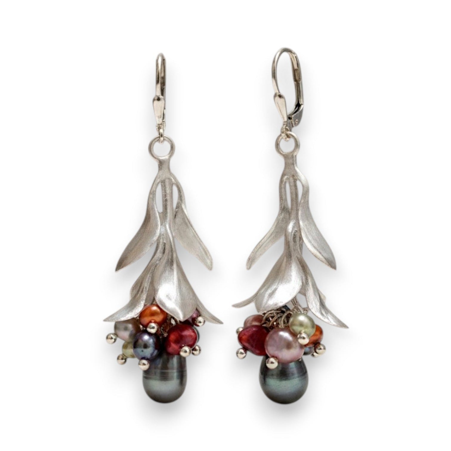Pair of silver earrings with colored pearls on a white background