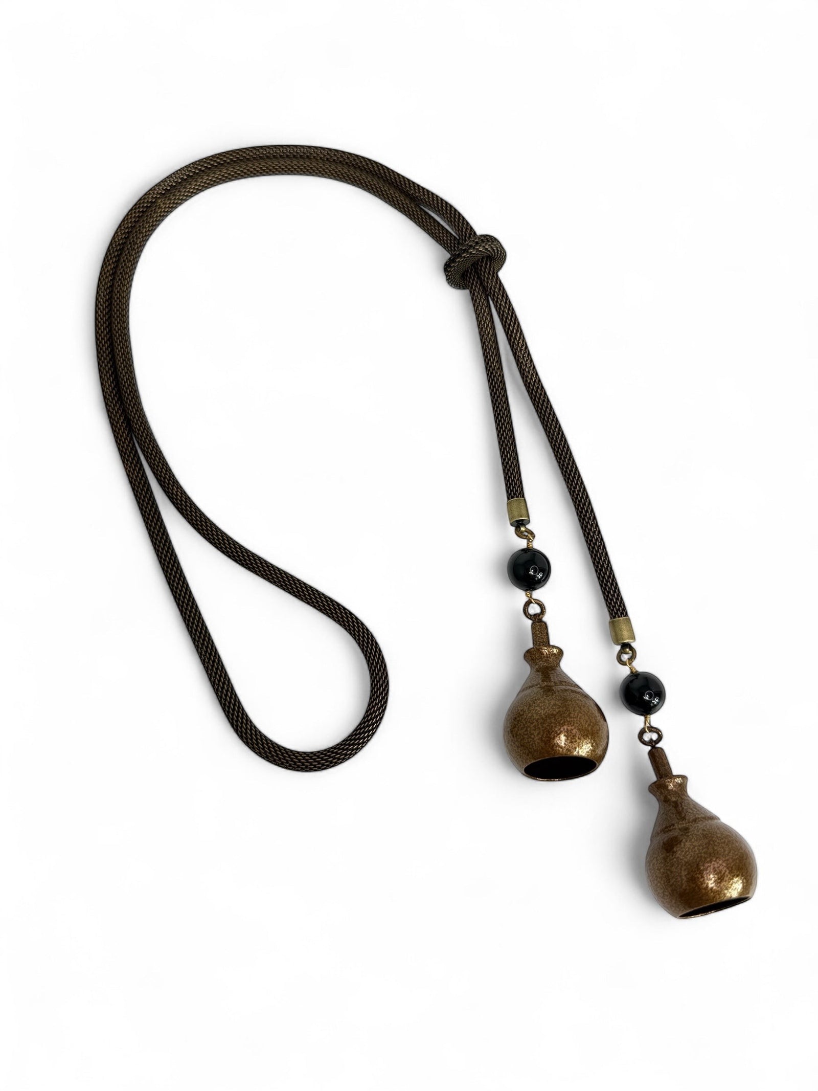 Erica Zap Designs mesh bolo necklace with antiqued brass base, copper electroplated bell ends, and black beads. 36" adjustable.