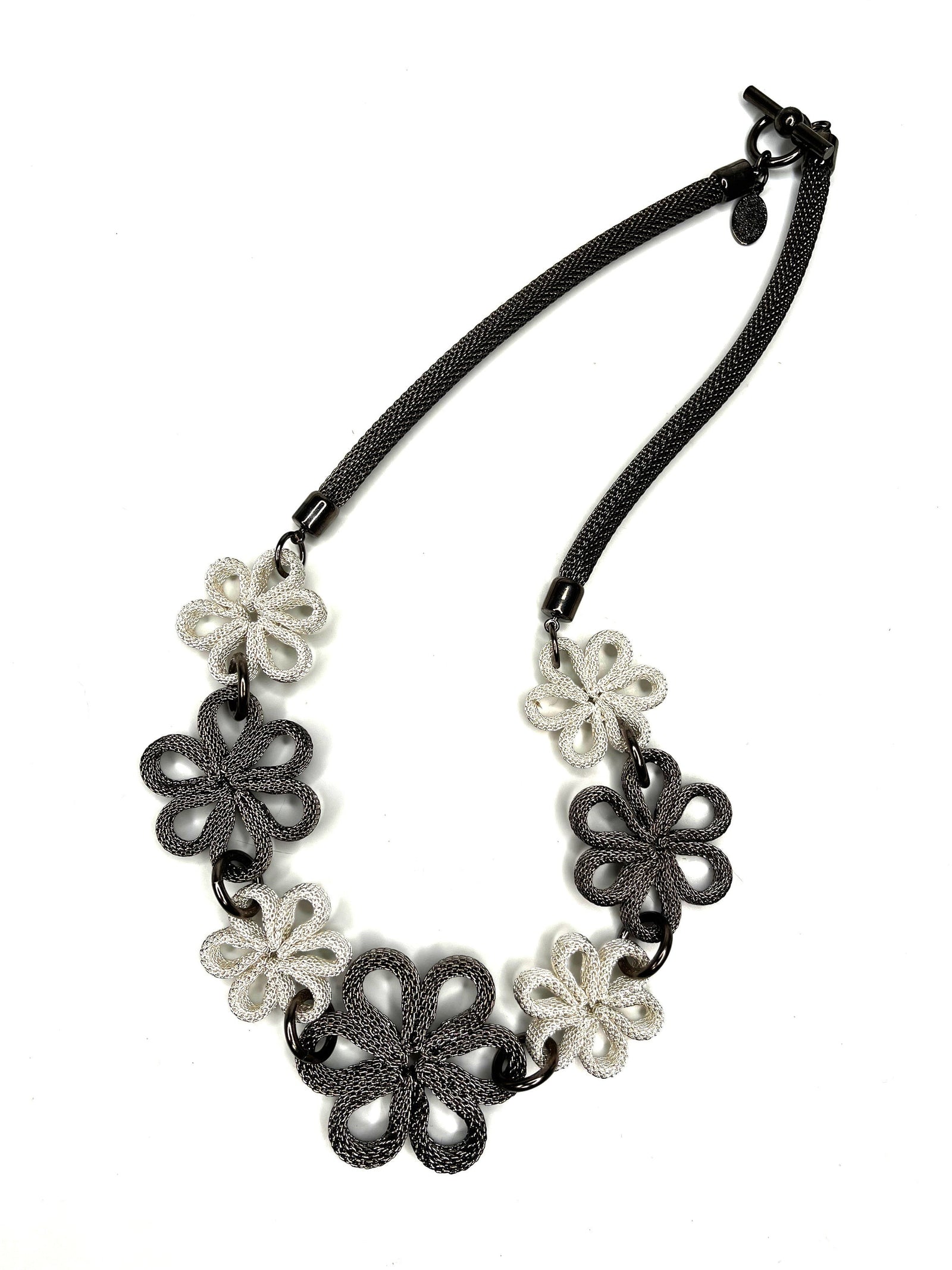 Erica Zap Designs mesh daisy necklace featuring alternating silver and black gunmetal flower charms on a toggle chain.
