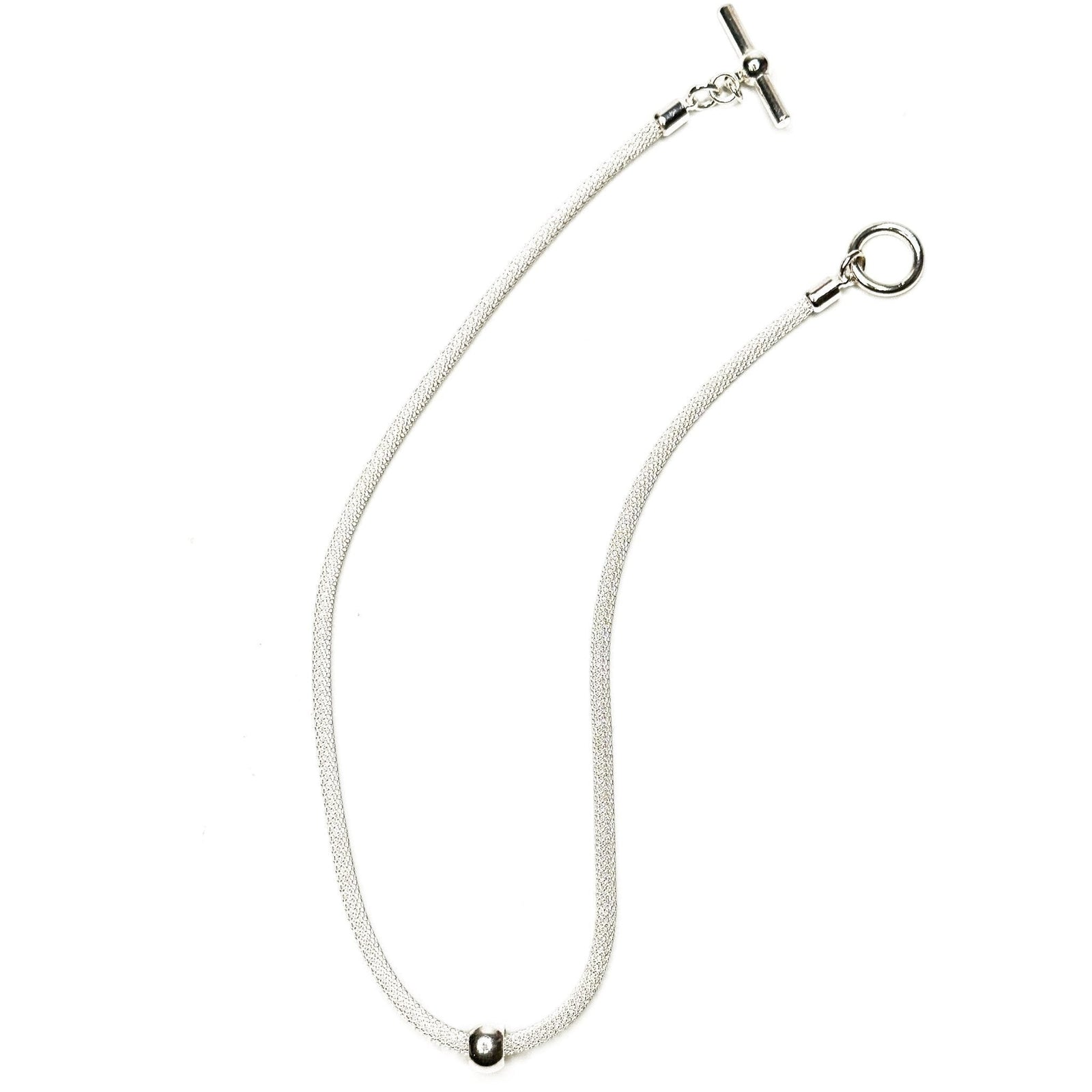 Erica Zap Designs silver mesh necklace featuring a delicate floating metal bead and a classic toggle clasp.